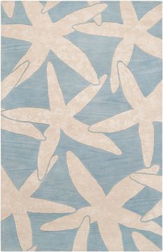 a blue and white rug with starfishs in the middle, on a white background