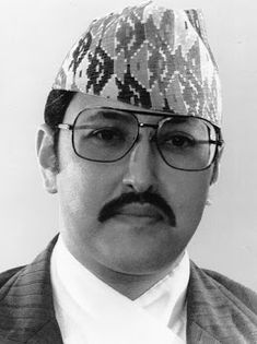 an old photo of a man wearing glasses and a knitted hat on his head