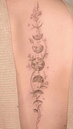 the back of a woman's upper arm with flowers and leaves on it