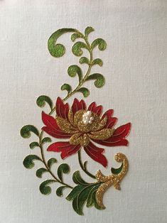 the embroidery design is done in gold, red and green