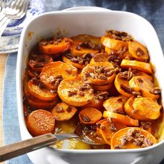 a casserole dish with carrots and meat in it