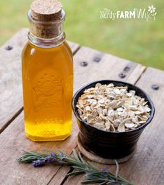 a bowl of oats next to a bottle of honey