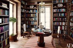 a room filled with lots of books and furniture