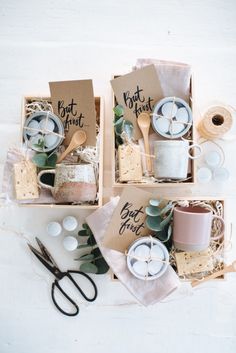 three boxes filled with different types of items on top of a white table next to scissors