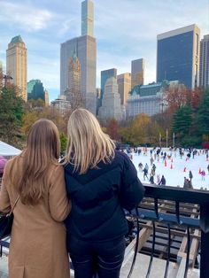 two women looking at an ice rink in the city