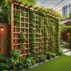 an outdoor living area with green plants on the wall and grass in the ground, surrounded by wooden trelliss