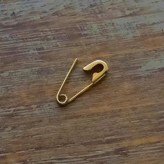 a pair of scissors sitting on top of a wooden table