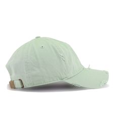 a light green baseball cap with ripped edges