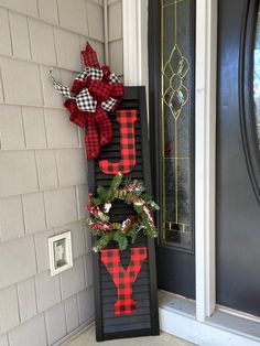 a red and black sign with the word joy hanging from it's front door