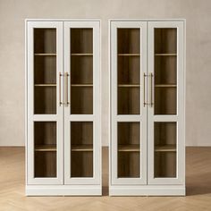 two white bookcases sitting side by side on top of a hard wood floor