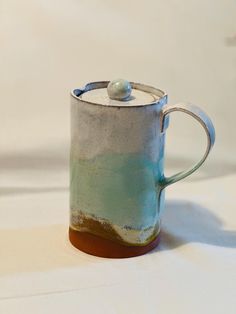 a blue and white mug sitting on top of a table