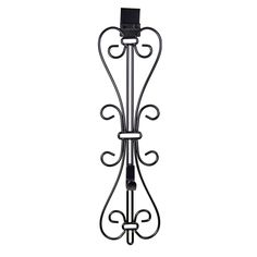 an iron candle holder with two candles on it