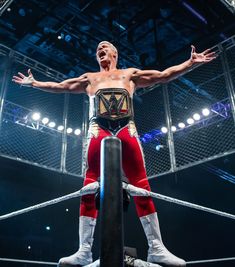 a man standing on top of a wrestling ring