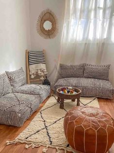 a living room with two couches and a coffee table in front of a window