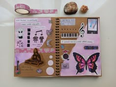 an open notebook covered in stickers and paper