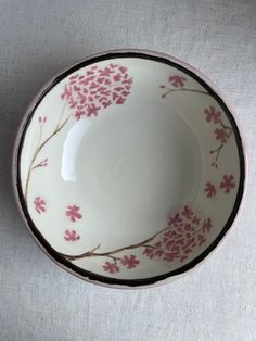 a white bowl with pink flowers on it