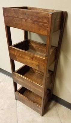 a wooden shelf sitting on top of a tiled floor