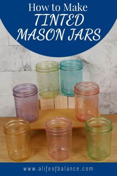 mason jars with the title how to make tinted mason jars on a wooden tray