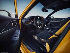 the interior of a yellow sports car