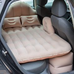 an inflatable mattress is placed on the back seat of a car