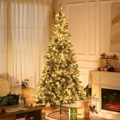 a living room with a lit christmas tree in the corner