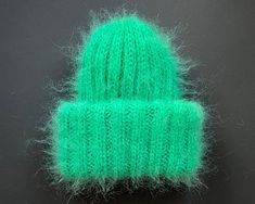 Chunky mohair beanie for women with double brim. This product is made especially for you as soon as you place an order. Please allow up to 3-7 business days production time before shipping. Colour name: GREEN. Made to order in 36 colors. Size: Stretch to fit ( 22-23 in / 56-58 cm) Composition: 50% mohair, 50% acrylic Recommended Care Instructions: Hand wash only. Dry flat. Made entirely by hand! Please note that real colors may slightly differ from their appearance on your display. Winter Soft Knit Green Hat, Green Soft Knit Winter Hat, Winter Green Soft Knit Hat, Green Winter Beanie Cap, Green Beanie Cap For Winter, Green Knitted Winter Hat, Green Winter Beanie One Size, Green One Size Beanie, Green Mini Cap For Winter