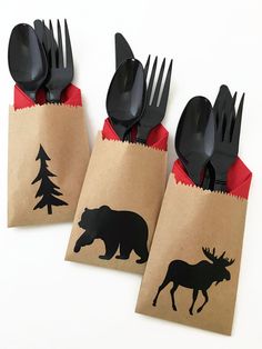 three bags with forks and spoons in them are decorated with black silhouettes of animals