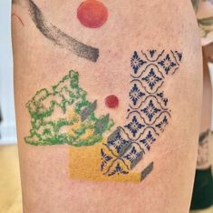 a colorful tattoo on the leg of a person