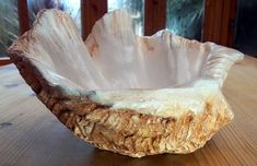 a wooden bowl sitting on top of a table