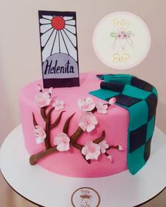 a pink and blue cake with flowers on it