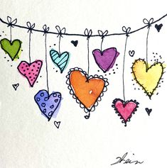 colorful hearts are hanging on a line with the word love written below them in cursive writing