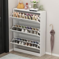 Create a clutter-free space for shoes or accessories with this clean-lined storage cabinet. Ideal for an entryway or living room, this cabinet features three drop-down drawers that open to reveal room for up to 18 of your favorite flats, sneakers, and heels. The freestanding frame is made from solid and engineered wood with a clean white finish that's scratch-free, and it rests on a plinth-style base for a complete the look. Plus, the surface on this cabinet is great for displaying accent pieces Flip Door, Narrow Shoe Rack, Entryway Shoe, Shoe Rack Organization, Narrow Shoes, Entryway Bedroom, Modern Shoes, Streamlined Design, Shoe Storage Cabinet