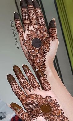 henna designs for hands and feet with intricate patterns on the palm, which is decorated with