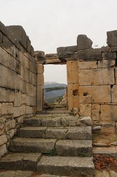 the stairs lead up to an old building with stone walls and steps leading into it