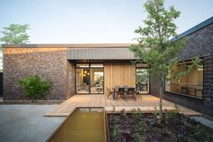 a wooden deck in front of a brick building