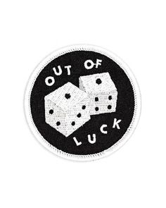 a black and white patch that says out of luck with dices in the middle