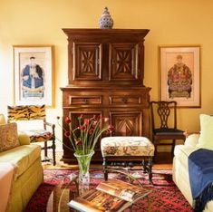 a living room with yellow walls and furniture