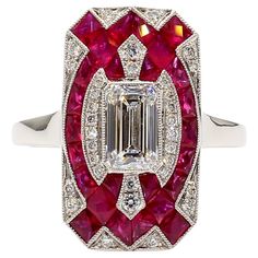 This Platinum Art Deco style ring features a stunning E/C diamond weighing 0.82 carats certified by GIA as E color and VS2 clarity. Adorned with smaller round diamonds totaling 0.15 carats and vibrant 1.31 carats of ruby, this ring exudes a lively and luxurious aura. The combination of classic design elements and unique gemstones creates a truly one-of-a-kind piece that is sure to turn heads and spark conversations wherever it is worn. Perfect for someone who appreciates timeless elegance with a touch of modern flair, this ring is a testament to exquisite craftsmanship and unparalleled beauty. KEY COMPONENTS: Diamond: 1 pc. - Emerald Cut - 0.82 CTS certified by GIA as EVS2 32 pcs. - Round full-cuts - 0.15 CTS non-certified Ruby: 32 pcs. - Mixed calibrated French-Cut- lively red color - Bur Luxury Art Deco Yellow Gold Ruby Ring, Luxury Art Deco Red Ruby Ring, Vintage Ruby Ring 1stdibs, Gia Certified Luxury Vintage Ruby Ring, Luxury Collectible Art Deco Ruby Ring, Contemporary Art Deco, Round Diamond Setting, Platinum Diamond Engagement Rings, Vs2 Diamond