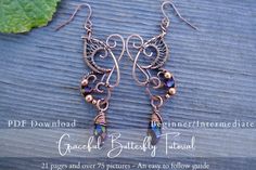 the earrings are made with copper wire and glass beaded beads, on top of a wooden