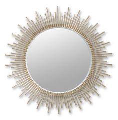 a round mirror with sticks in the shape of sunbursts on it's face