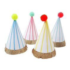 three party hats with pom poms on them