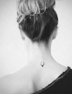 a woman with a small tattoo on her neck