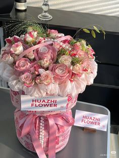 a pink flower box with flowers in it on display at a showroom or event