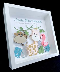 a shadow box with some cut out animals in it's center and the words charie marie simpsonon above it