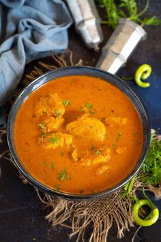 the recipe for goan fish curry is shown in a bowl with an arrow pointing to it