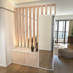 a living room filled with furniture and wooden slats on top of a hard wood floor