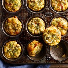 several muffins with different toppings sitting in a pan on top of a table