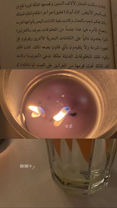 a candle is lit in front of an open book with arabic writing on the pages