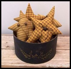 a basket filled with wooden stars on top of a table