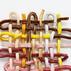 an assortment of different colored links on a white surface